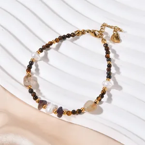 Exquisite detail of a retro tiger eye and agate beaded bracelet with natural pearls and gold beads