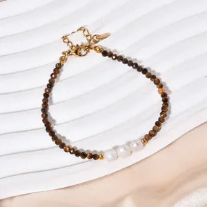 Close-up of faceted tiger eye beads and white pearls on a retro style beaded bracelet