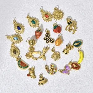 Detailed view of various gold-plated titanium steel charms including fruit and animals