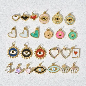 Detailed view of assorted DIY pendants with evil eye, heart, and celestial motifs in gold