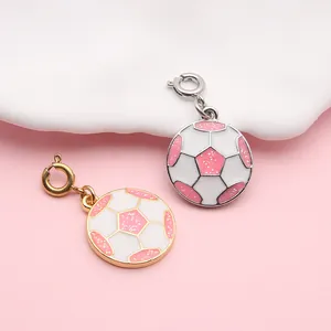 Detailed view of pink and white enamel soccer ball charms with glitter for DIY jewelry