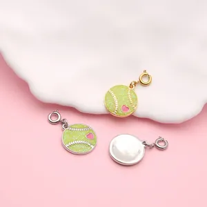 Close-up of glitter baseball charms with enamel heart details for DIY jewelry
