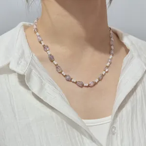 Natural purple crystal and white beaded necklace worn on neck with white linen shirt