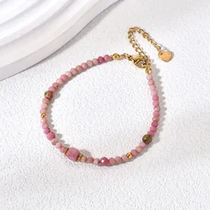 Detailed view of elegant pink natural stone bead bracelet with a delicate golden heart charm