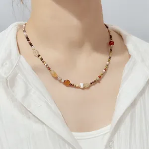 Macro view of colorful natural stones and tiny seed beads on a handmade necklace