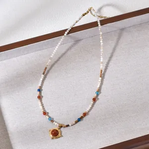 Close-up of Bohemian beaded necklace with round stone pendant in a display tray