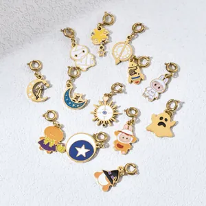 Close-up view of various colorful enamel Halloween and space charms with gold-toned finish