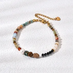Macro view of handmade beaded bracelet featuring colorful natural stones and pearl