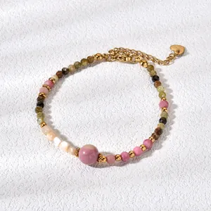 Close-up detail of candy colored natural tourmaline and agate beads on gold bracelet