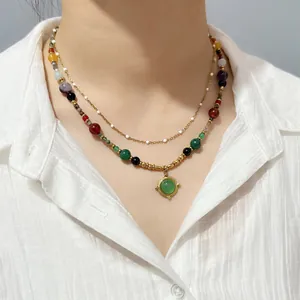 Close-up of vintage ethnic style beaded necklace with agate stones worn on neck