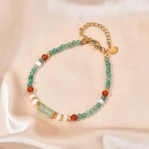 Detailed close-up of a colorful natural stone bead bracelet with gold-tone hardware