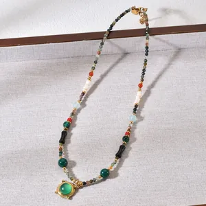 Detailed view of a vintage beaded necklace with natural agate and tiger eye stones.