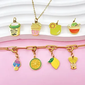 Detailed view of colorful enamel fruit and food charms on a gold chain necklace.