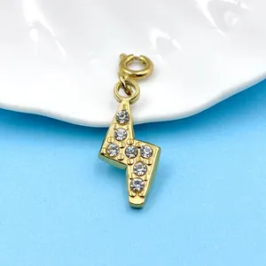 Macro view of 18K gold-plated lightning bolt charm with sparkling crystal inlay