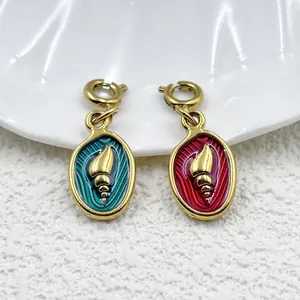 Detailed view of 18K gold-plated stainless steel conch shell pendants in teal and red.