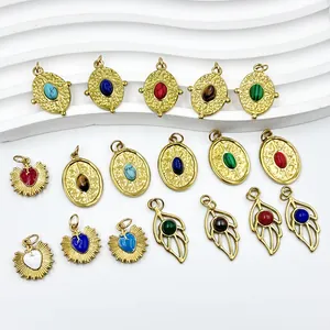 Detailed view of 18K gold plated stainless steel heart, oval, and leaf pendants.