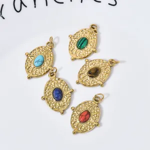 Detailed view of vintage oval pendants with colorful natural stones and gold finish.