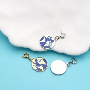 Detailed macro shot of globe-patterned enamel charms in gold and silver finishes.