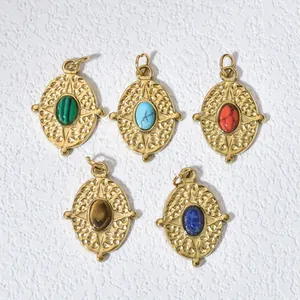 Detail view of five vintage gold-plated oval pendants with colorful natural stones