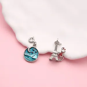 Detail of alloy enamel charms featuring Eiffel Tower and moonlit starry sky designs