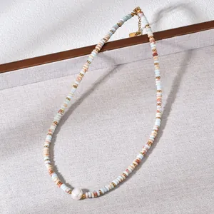 Detailed close-up of a natural stone beaded necklace with a large freshwater pearl