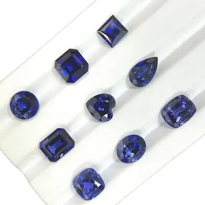 Lab-grown royal blue sapphire loose gemstones in various cuts on a white tray