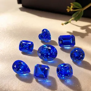 Collection of various shaped lab-grown blue cobalt spinel loose gemstones on light background