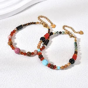 Close-up of retro bracelets with colorful natural stone beads and elegant gold chains