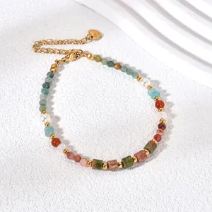 Detail showing colorful natural stone beads and gold-plated heart tag on a bracelet