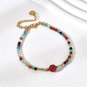 Detail of a retro colorful natural stone beaded bracelet with gold chain and heart tag.