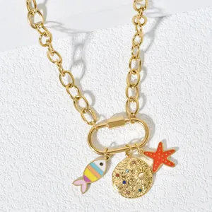 Detailed view of a gold stainless steel necklace featuring fish, sun disk, and starfish charms