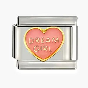 Macro view of stainless steel modular charm with pink enamel heart and 'Dream Girl' text
