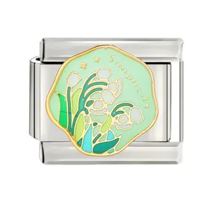 Macro view of green enamel floral lily pattern on stainless steel Italian charm link
