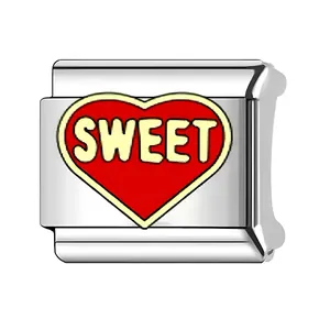 Detailed macro view of a silver stainless steel heart charm with 'SWEET' engraving