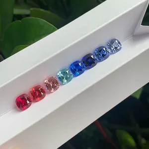 Professional showcase of loose cushion-cut lab-grown colored gemstones in vibrant hues