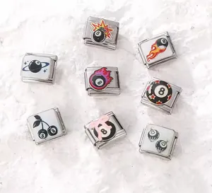 Detailed view of stainless steel Italian charm links with varied 8-ball designs.
