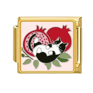 Detailed view of an Italian charm link with a cat and pomegranate enamel design.
