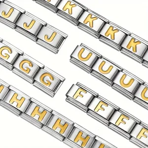 Close-up detail of stainless steel Italian charm bracelet with golden letter engravings