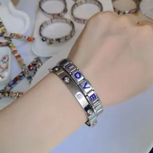 Detailed view of stainless steel modular LOVE bracelet and screw design bangle