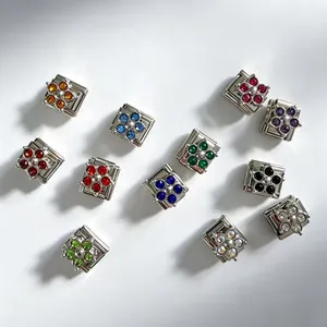 Selection of colorful zircon clover stainless steel modular links for DIY Italian bracelets.