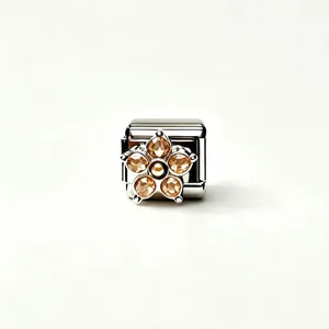 Detailed macro view of a stainless steel Italian charm featuring a yellow zircon flower