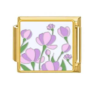Macro view of gold stainless steel Italian charm module featuring purple flower enamel art