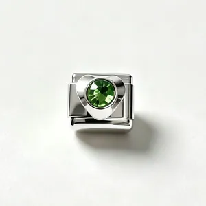 Close-up of a stainless steel heart charm link with a green faceted zircon stone.