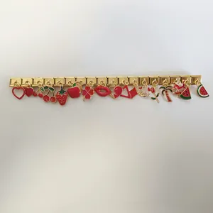 Bracelet modulaire italien en acier inoxydable doré avec divers pendentifs en émail rouge
