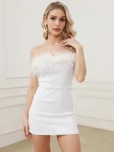 Detailed shot of a white sequined mini dress featuring elegant ostrich feather trim