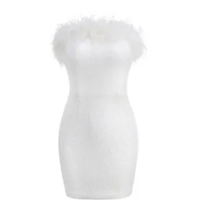Detailed close-up of white sequin mini dress featuring elegant ostrich feather trim