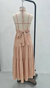 Back detail showing the large tie-up bow and tiered design of the halter maxi dress.