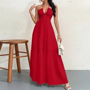 Detail of red halter neck tiered maxi dress showing fabric texture and flowy fit