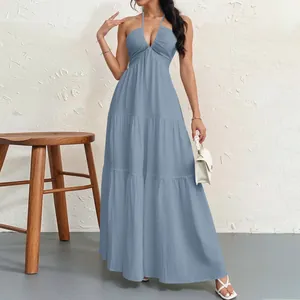 Elegant dusty blue halter neck tiered maxi dress shown in full length on a model