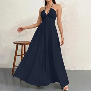 Elegant navy blue halter maxi dress featuring a tiered skirt and flowy silhouette